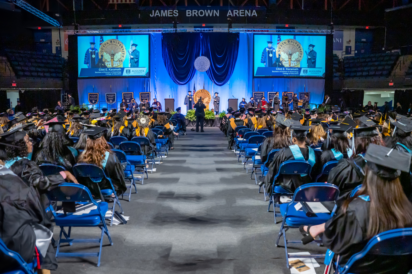 Augusta University graduation showing a student accepting his diploma from the President of the college.