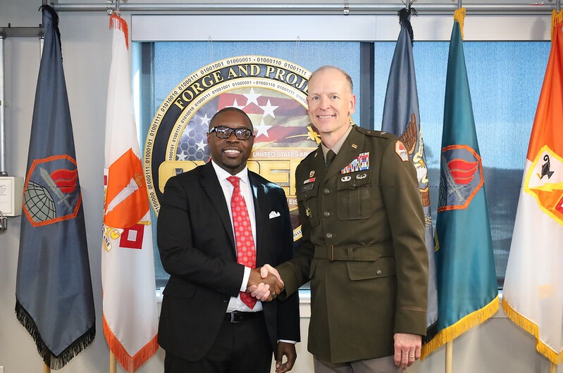 Dr. Jermaine Whirl and Brigadier General Mark Miles shaking hands.