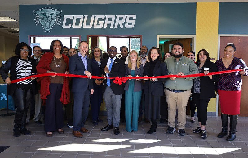 Dr. Jermaine Whirl, President of Augusta Tech, Amy Breitmann, President of Golden Harvest Food Bank, and Russell Lahodny, President of the Columbia County Chamber of Commerce stand with Augusta Tech Staff in front of the Paws Pantry at the Ribbon Cutting Ceremony.